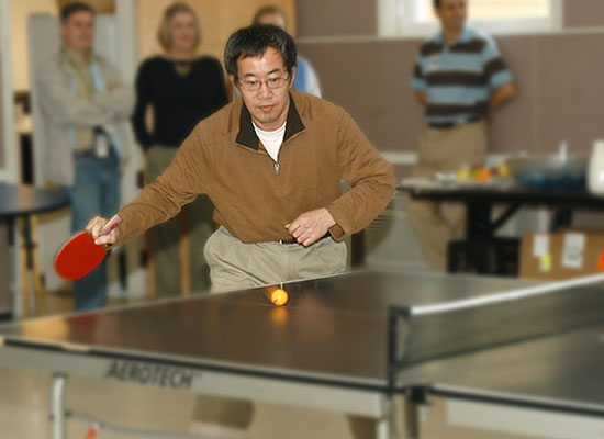 photo of man playing table tennis in recreaction hall
