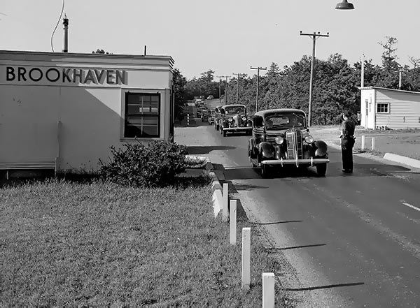 photo of 1940s cars entering a guard gate