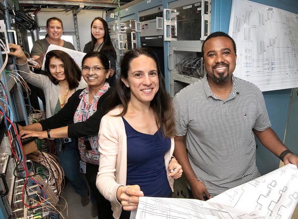 photo of five women and one man with research hardware