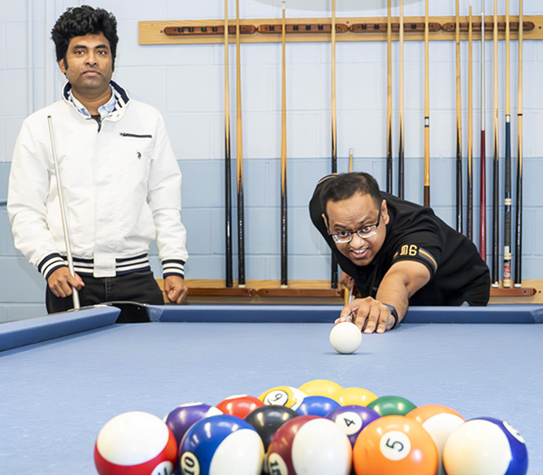 photo of three people playing billiards