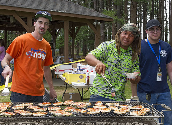 photo of three men grilling outdoorsl