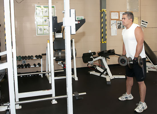 photo of man with wieght lifting equipment