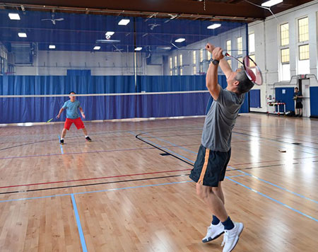photo of two people playing badminton