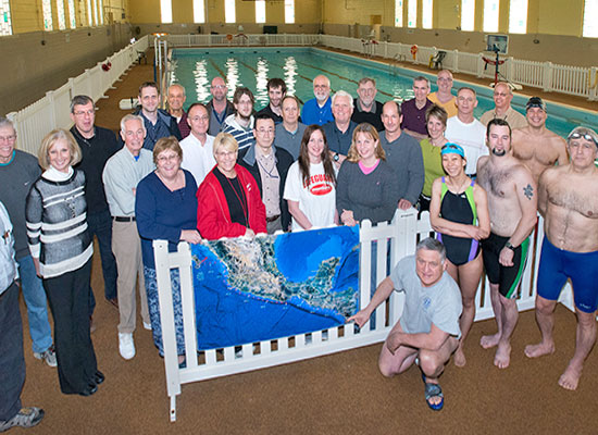 photo of crowd posing in front of pool