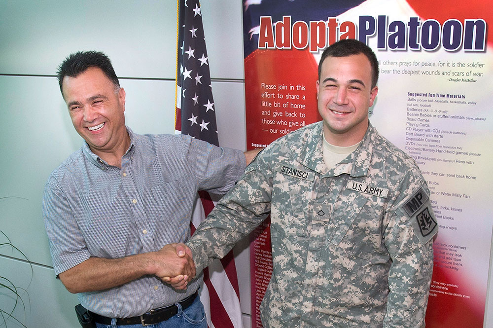 photo of soldier shaking hands with Brookhaven employee