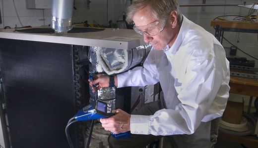 photo of researcher with furnace analysis equipment
