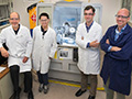 August 2013: John and Mark with collaborators Ivan Bozovic and Yujie Sun standing in front of the diffractometer that was used to characterize the films for their recent publication.