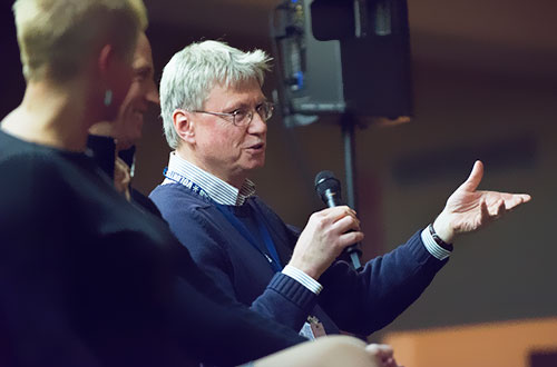photo of man speaking into a microphone