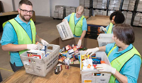 photo of employees loading food parcels