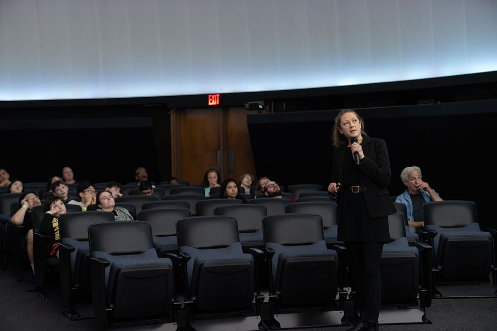photo of a scientist presenting in a planetarium