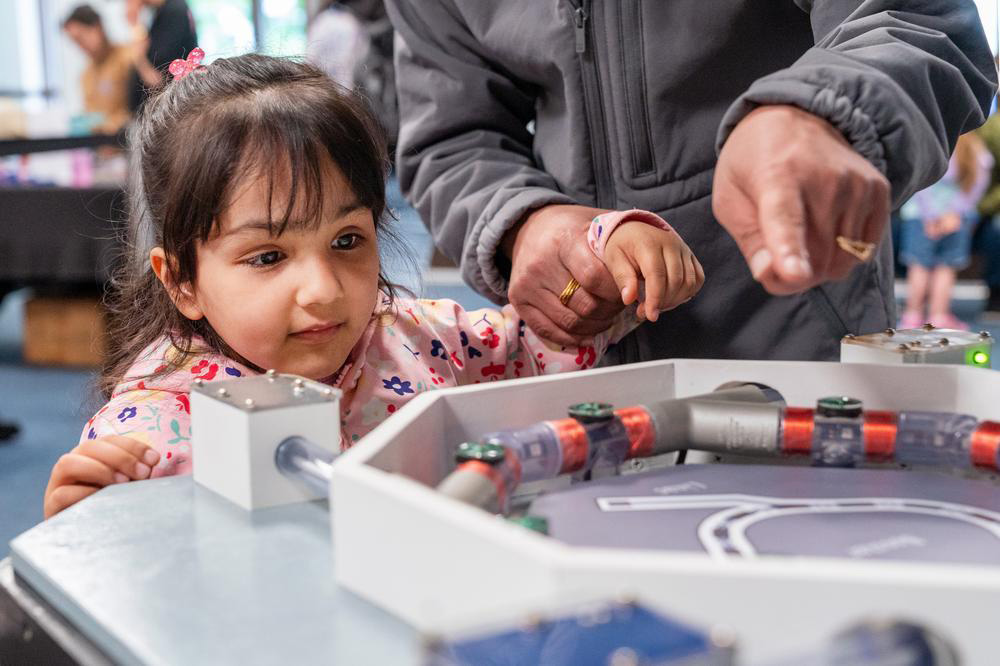 photo of the Science in the a girl with a science demostration table