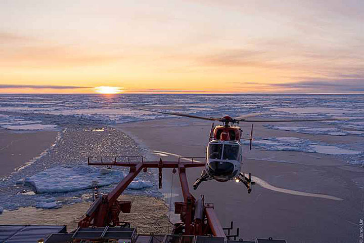 helicopter returning scientists from a nearby ice floe