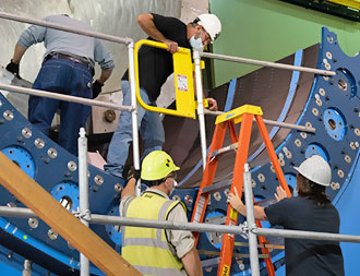 photo of workers building the sphenix detector