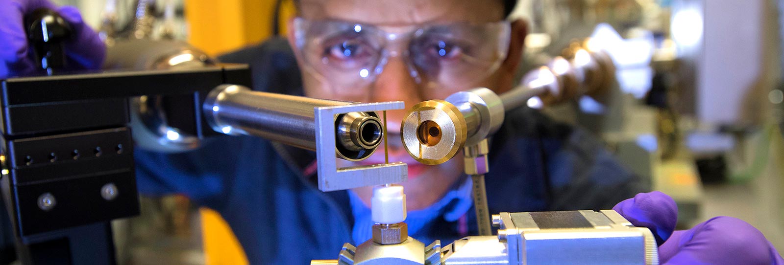 photo of researcher at beamline instrument