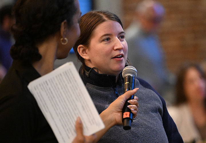An audience member asks a question