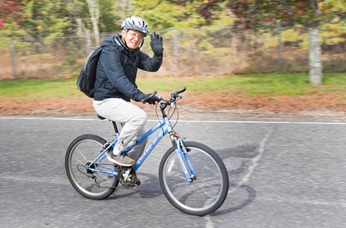 photo of a man riding a bicycle