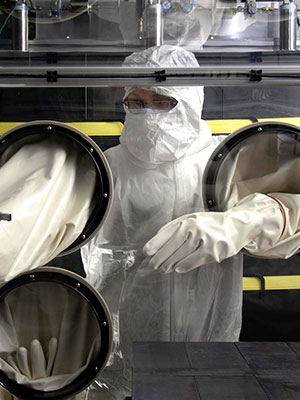 photo of worker at glove box in underground laboratory