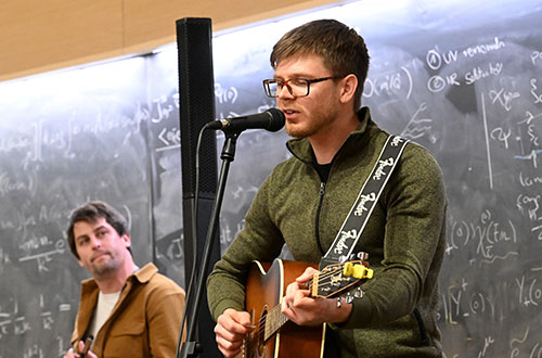 photo of man singing and pkaying guitar