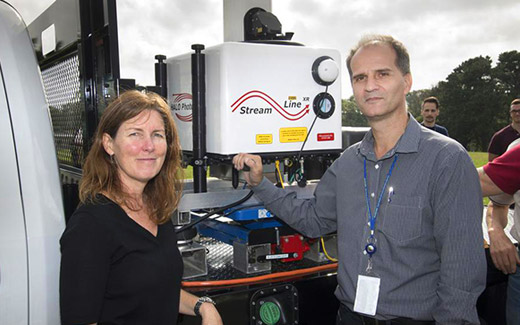 photo of two scientists standing in front of air sampling equipment