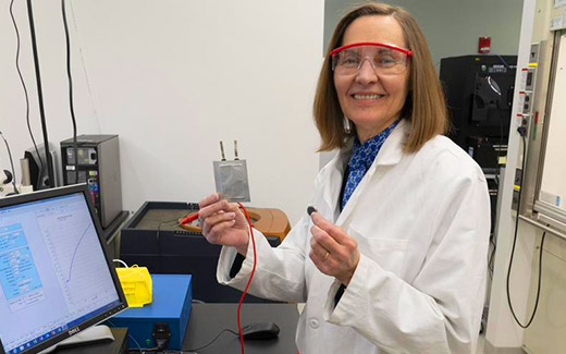 photo of scientist holding a small battery