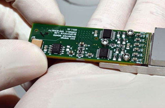 photo of gloved hand holding an electronic device