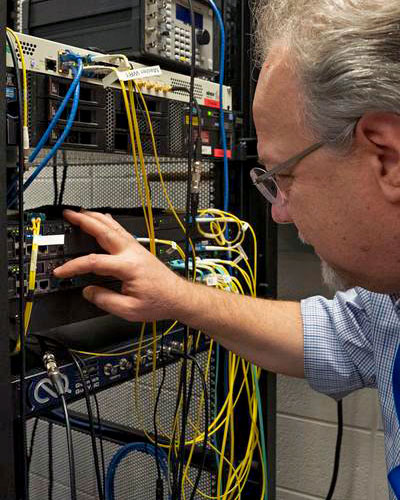 photo of man adjusting electronics