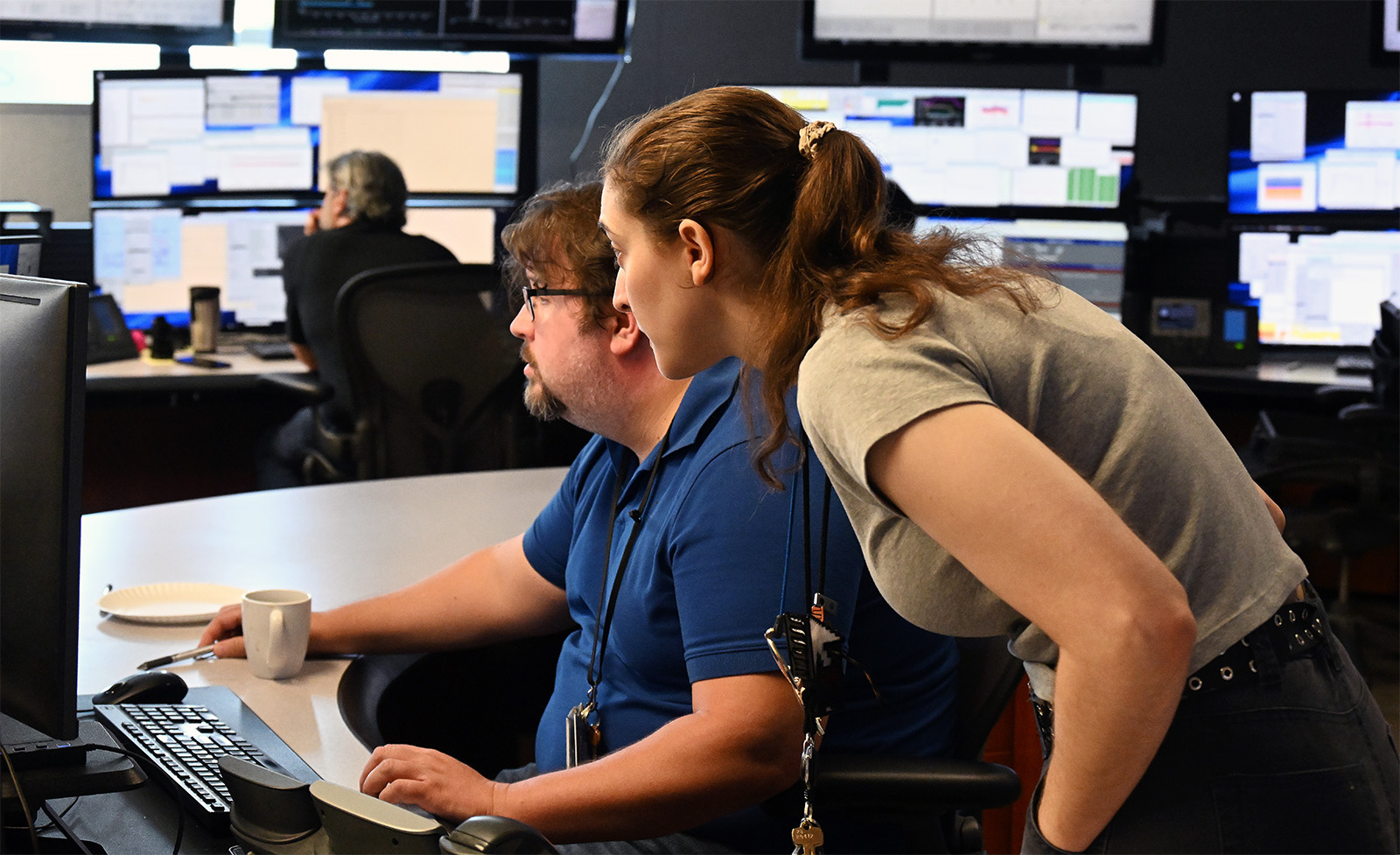 photo of two people staring at a computer screen