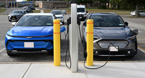 photo of electric cars plugged into charging    station