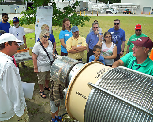 photo of visitors looking at an accelerator magnet