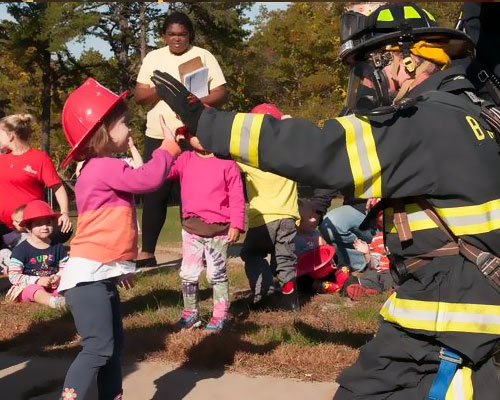 photo of a family sitting on a fire truck
