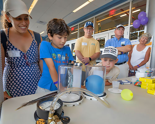 photo of a family looking at a science exhibit