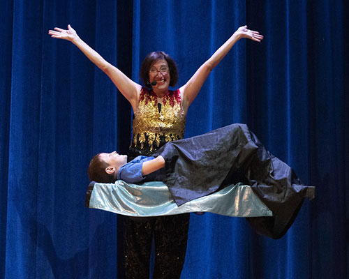 photo of magician performing levitation trick
