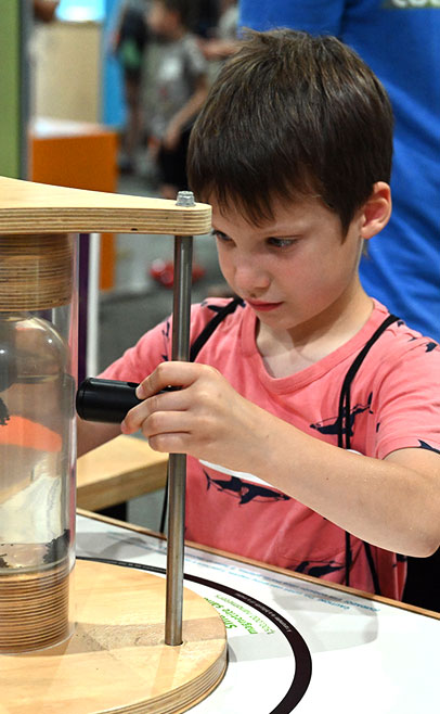 photo of boy examining scientific device