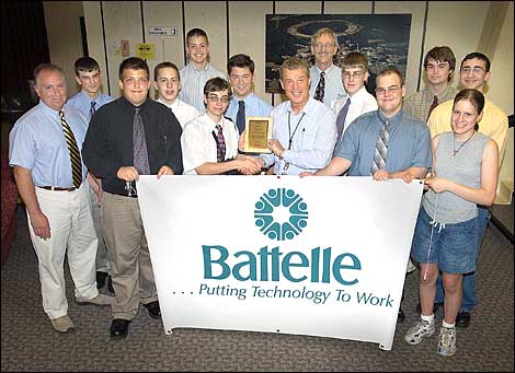 Greg Fess accepts plaque on behalf of Battelle