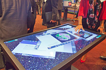 large scale touch-table display featuring images from DOE-sponsored research