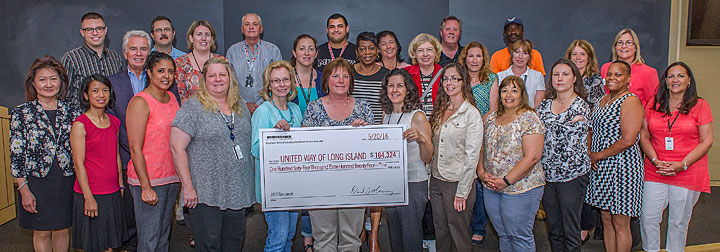 Lab staff present a check