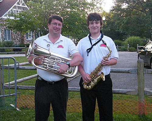 Jensen and his son, Mack, pose near home with their musical instruments