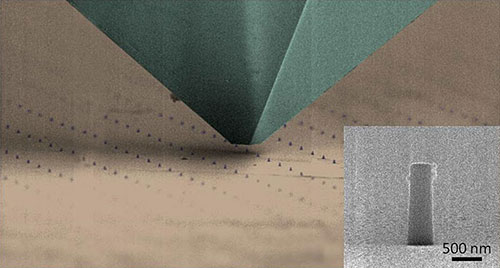 Scanning electron microscope image of a nanomechanical testing tip passing over arrays of the hybrid