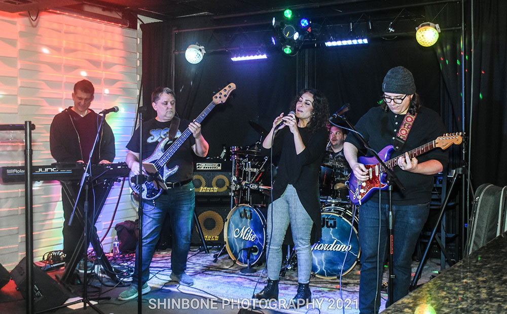 Photo of Jentsch, far right, playing guitar with his 80s cover band, VHS