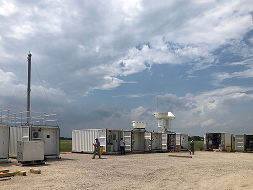 Photo of a series of containers outfitted with sophisticated atmospheric and meteorological sampling