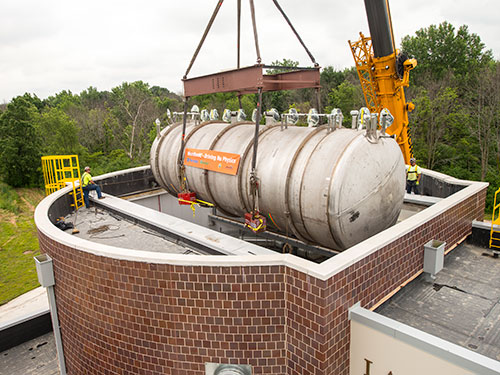 Photo of MicroBooNE detector being lowered into facility