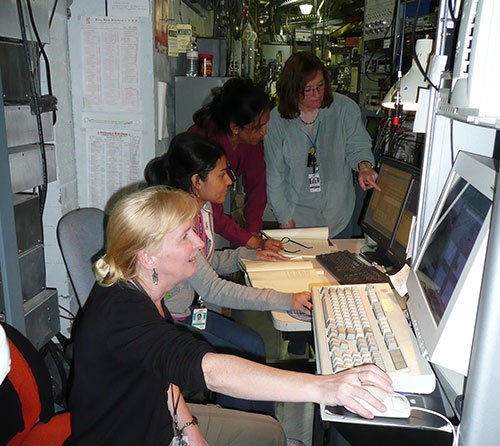 Photo of Jean Jordan-Sweet (in the back) with three other researchers