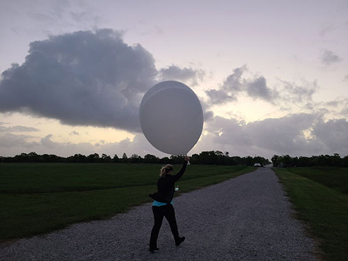 Photo of Michelle Kiani launcheing a weather balloon