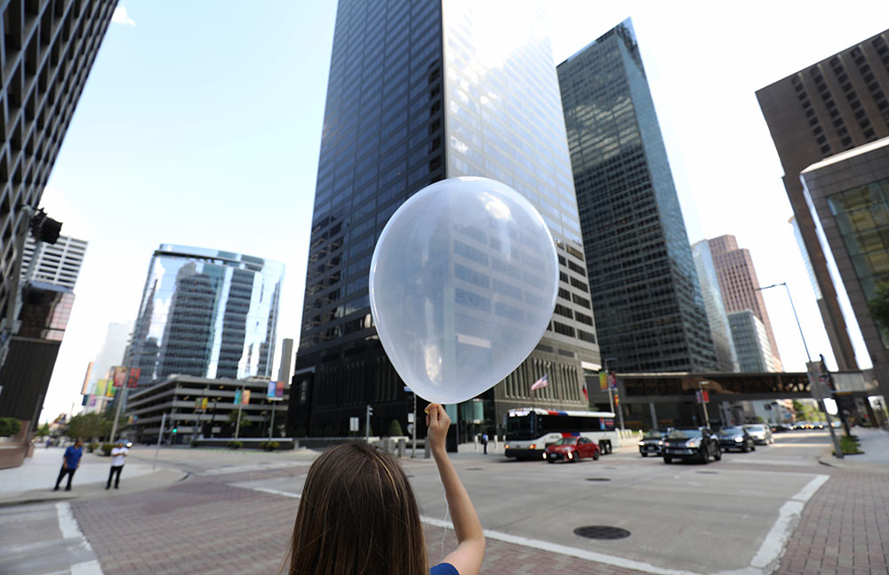 Photo of Katia Lamer as she prepares to release a mini radiosonde balloon in Houston, Texas