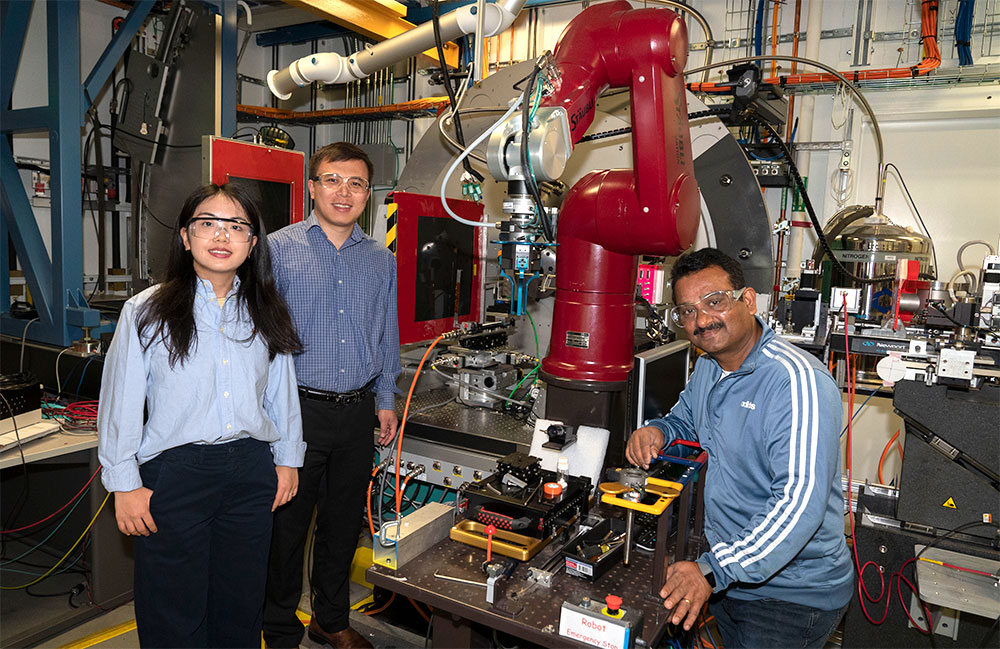 Photo of Sha Tan and Enyuan Hu with beamline scientist Sanjit Ghose