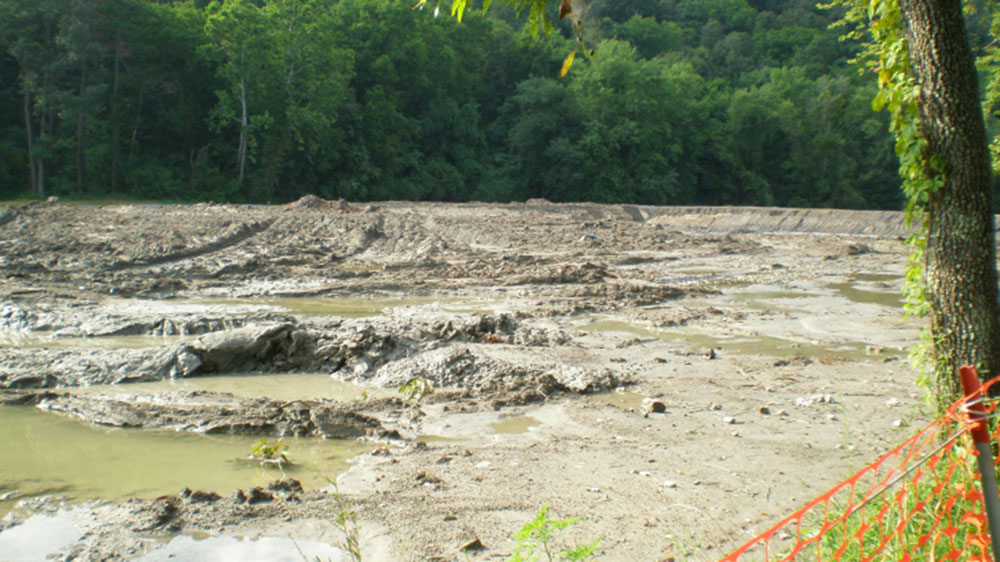 a wide field of mud with puddles throughout