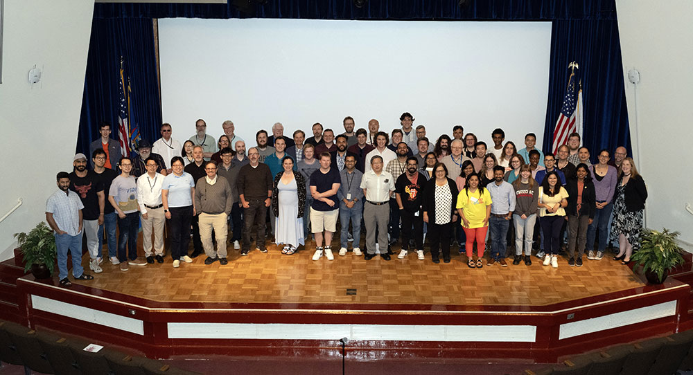 Users' meeting participants pose for group photo on stage
