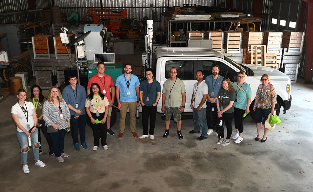 Program particpants pose for a group photo with mobile observatory