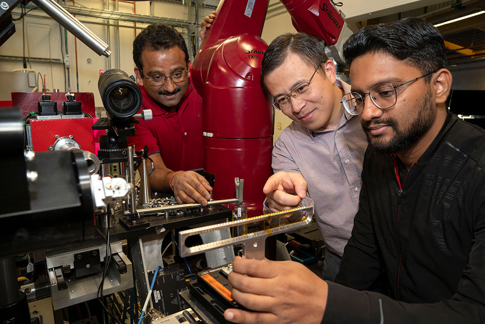 Sanjit Ghose, Enyuan Hu, Muhammad Mominur Rahman adjust beamline