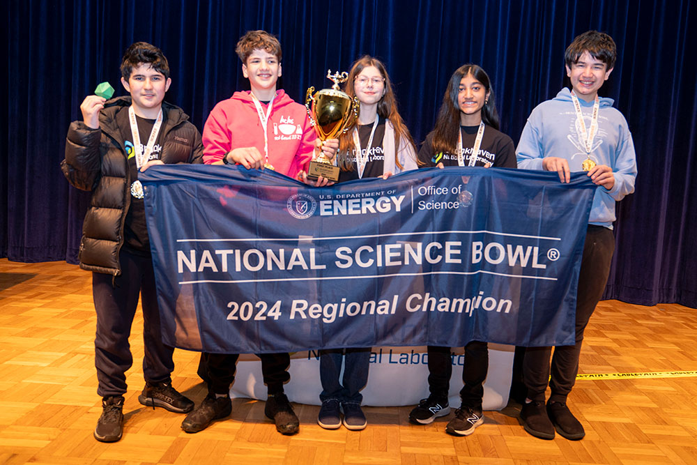 Five students hold a banner that reads National Science Bowl 2024 Regional Champion